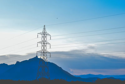 Low angle view of electricity pylon against sky