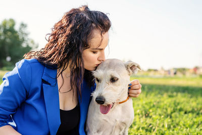 Woman with dog on field