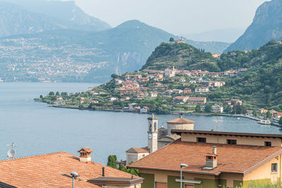 High angle view of townscape by sea against mountain