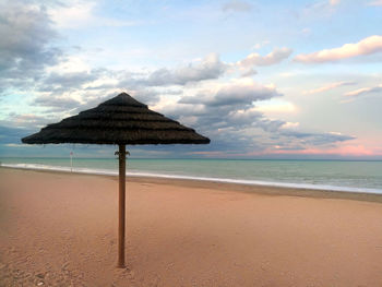 Lifeguard hut on beach against sky