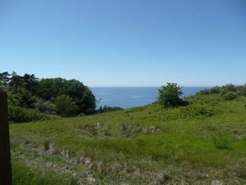 Scenic view of sea against clear blue sky