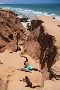 High angle view of people on rocks at beach