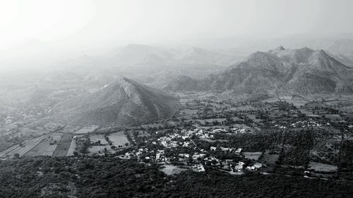 Aerial view of landscape against sky during foggy weather