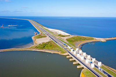 High angle view of bridge over sea against blue sky