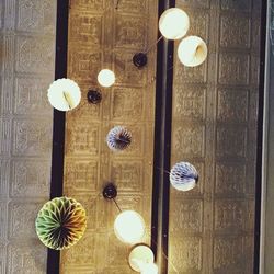 Low angle view of illuminated light bulb hanging