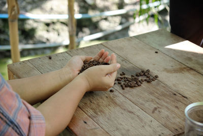 Low section of woman relaxing on wood