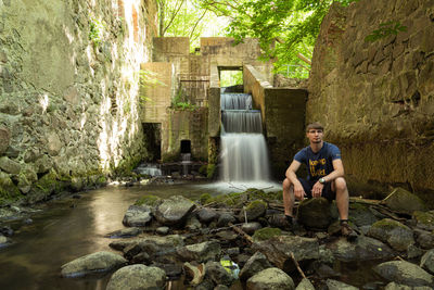 Portrait of a man sitting on rock