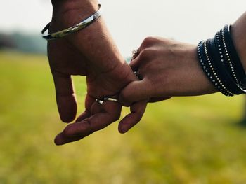 Close-up of couple holding hands