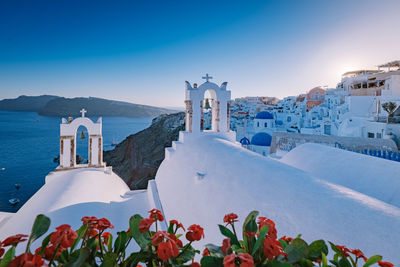 Scenic view of building by mountains against blue sky