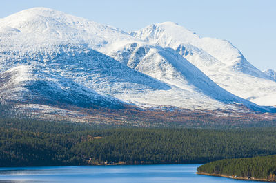 Lake in front of snowcapped mountain landscape, norway.