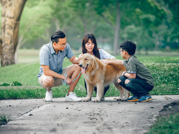 Rear view of people with dog