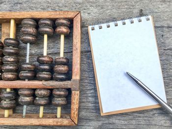 Directly above shot of book with abacus on table