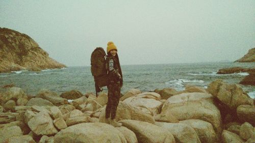 Scenic view of rocks at beach against sky