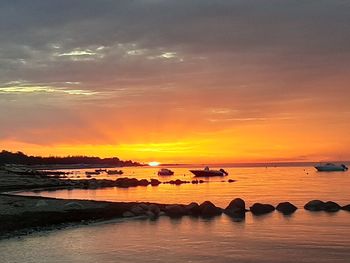 Scenic view of sea against romantic sky at sunset