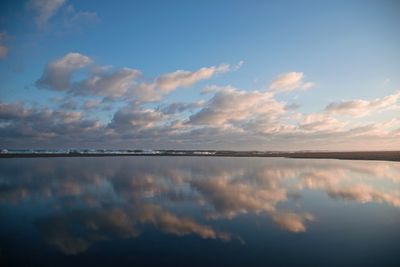 Scenic view of lake against sky at sunset