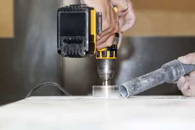 Midsection of man working on table