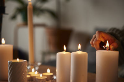 Woman lighting candles at home