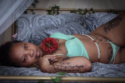 Portrait of smiling girl lying on bed