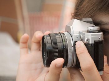 Midsection of woman photographing through camera