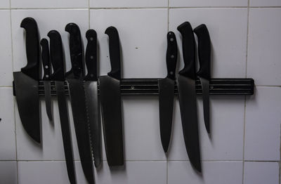 Close-up of various objects on table against wall