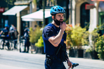 Man standing on street in city