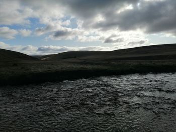 Scenic view of landscape and sea against sky