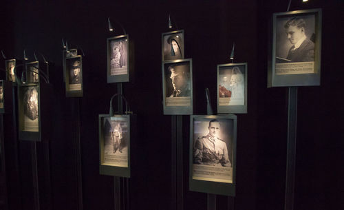 Illuminated lighting equipment hanging on wall in museum