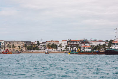 Boats in sea against sky