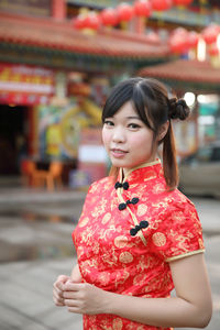 Portrait of young woman standing outdoors