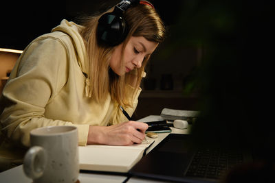 Female designer working in home office at night