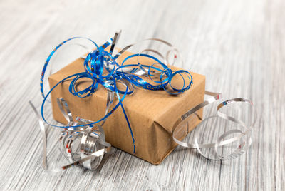 High angle view of christmas present on wooden table