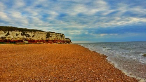 View of beach against cloudy sky