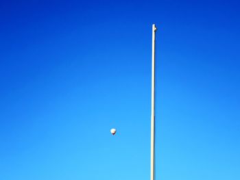 Low angle view of kite against clear blue sky