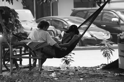 Rear view of couple sitting outdoors