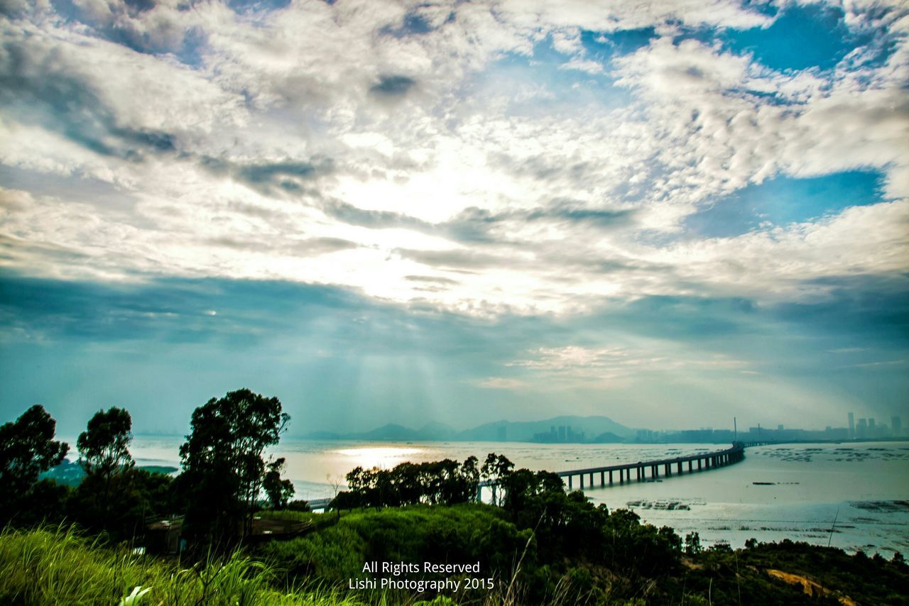 water, sky, tranquil scene, scenics, tranquility, cloud - sky, beauty in nature, sea, nature, cloudy, tree, cloud, idyllic, horizon over water, river, lake, plant, landscape, non-urban scene, outdoors