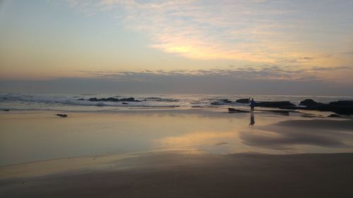 Scenic view of beach against sky during sunset