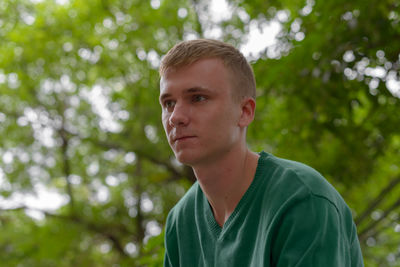 Portrait of young man against plants