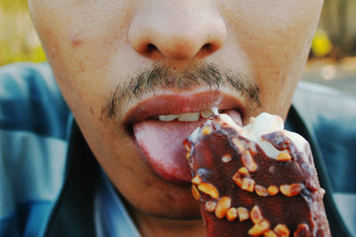 Close-up of man eating ice cream