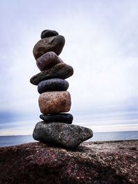 Close-up of rocks on beach against sky