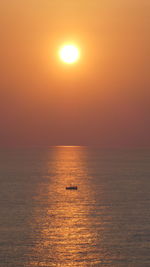 Scenic view of sea against orange sunset sky