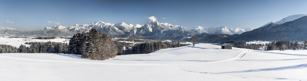 Panoramic view of snow covered land