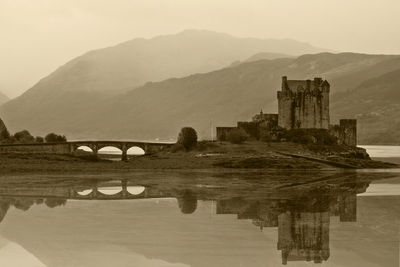 Bridge over lake against mountain range