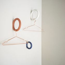 Empty coathangers hanging by wall at home