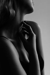 Black and white woman body closeup on white background, nude, hands, arms, skin and dark tones