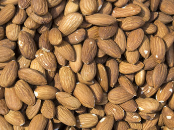 Full frame shot of almonds for sale at market stall during sunny day