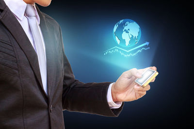 Digital composite image of businessman using mobile phone