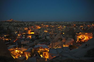 High angle view of illuminated buildings against sky at night