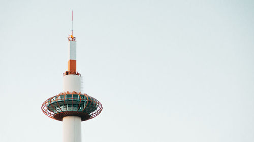 Low angle view of communications tower against sky