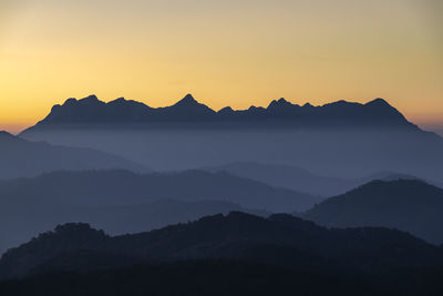 Scenic view of silhouette mountains against sky during sunset