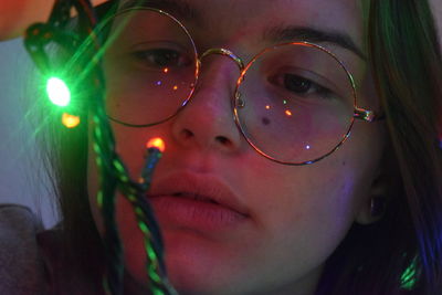 Close-up portrait of woman with light painting